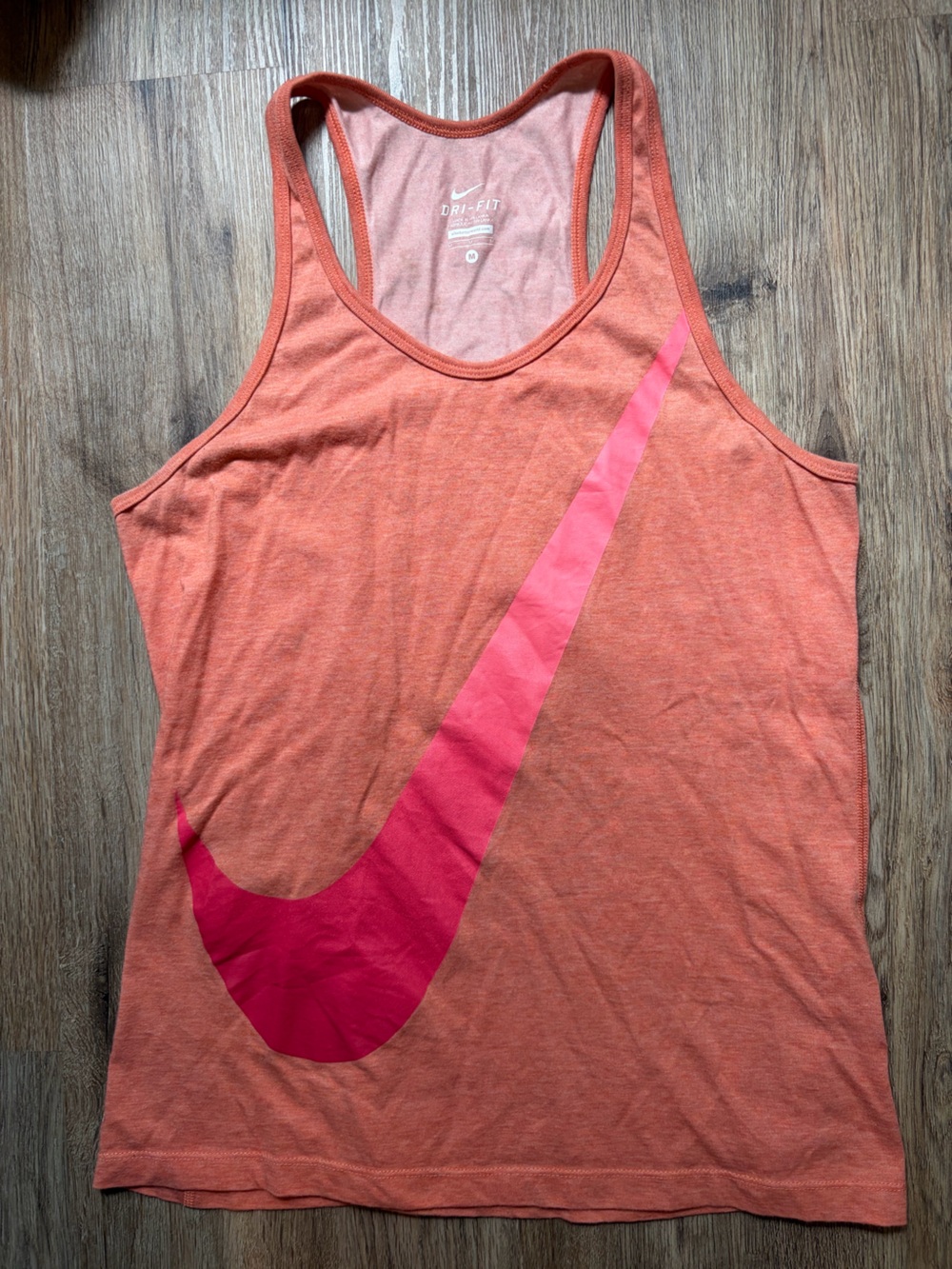 Nike Women’s Coral-Orange Workout Outdoor Tank Top with Pink Swoosh Symbol
